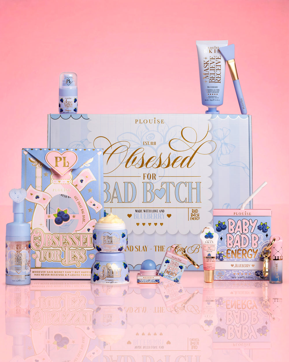 Products and packaging of the P.Louise Obsessed For Bad Bitch Bundle against a pink background