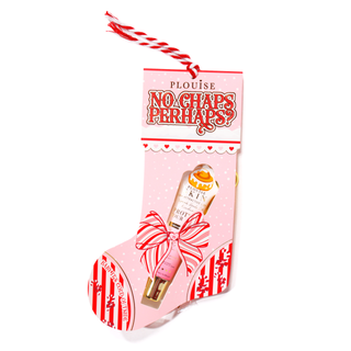 Pink cardboard stocking with red text and decorative elements with a red and white rope attached containing a cinnamon roll lip conditioner on a white background